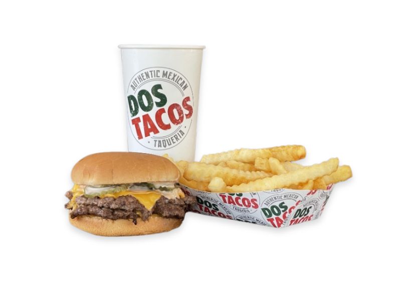 A large double smash burger on a sesame seed bun, featuring two beef patties, two slices of cheese, pickles, and special sauce.